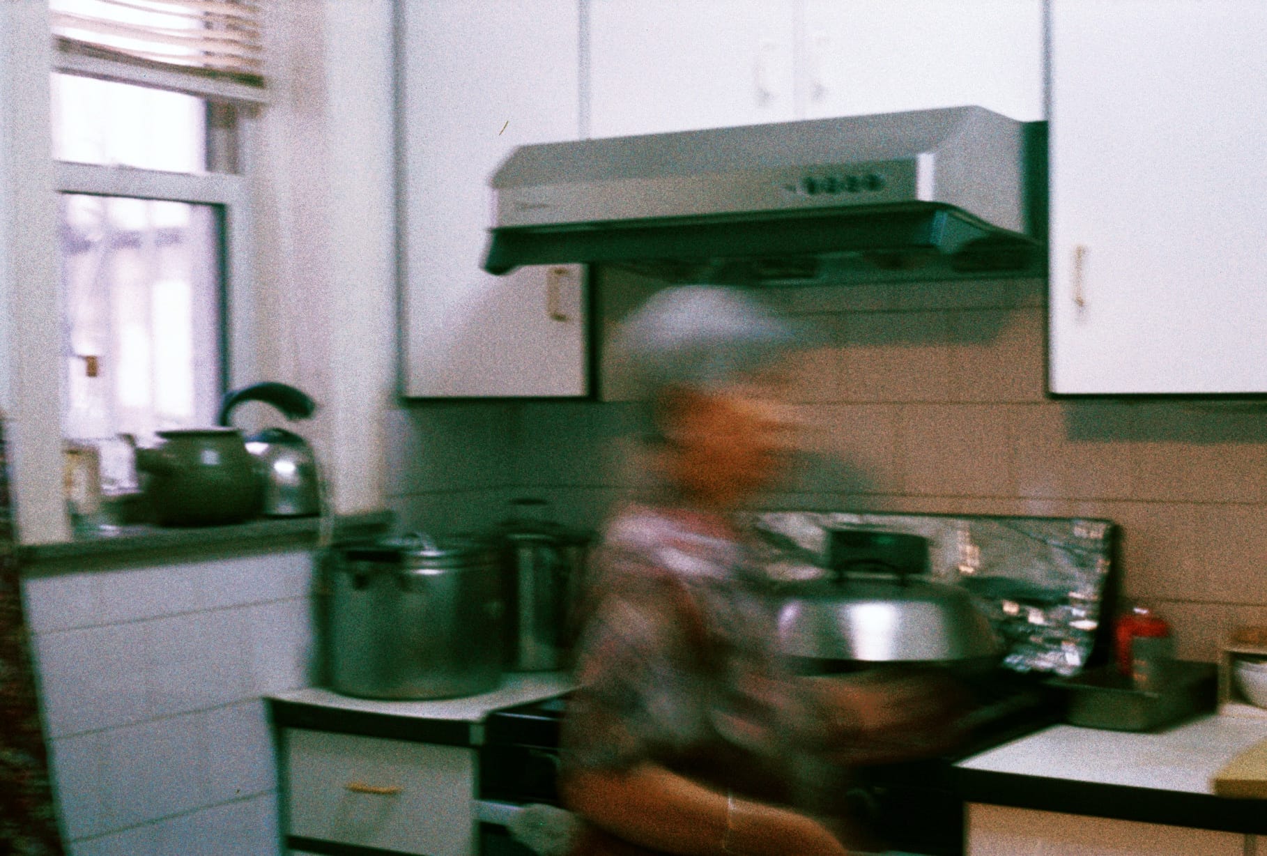 奶奶 entertained my interests in the film camera's for a bit, but she's a busy lady! The dishes are waiting for her at the sink, just to the right of the frame, where she travels off to.